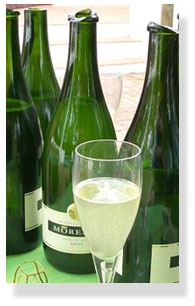 Bottles after sabrage, showing how the neck containg the cork shears off after being struck at the rim 